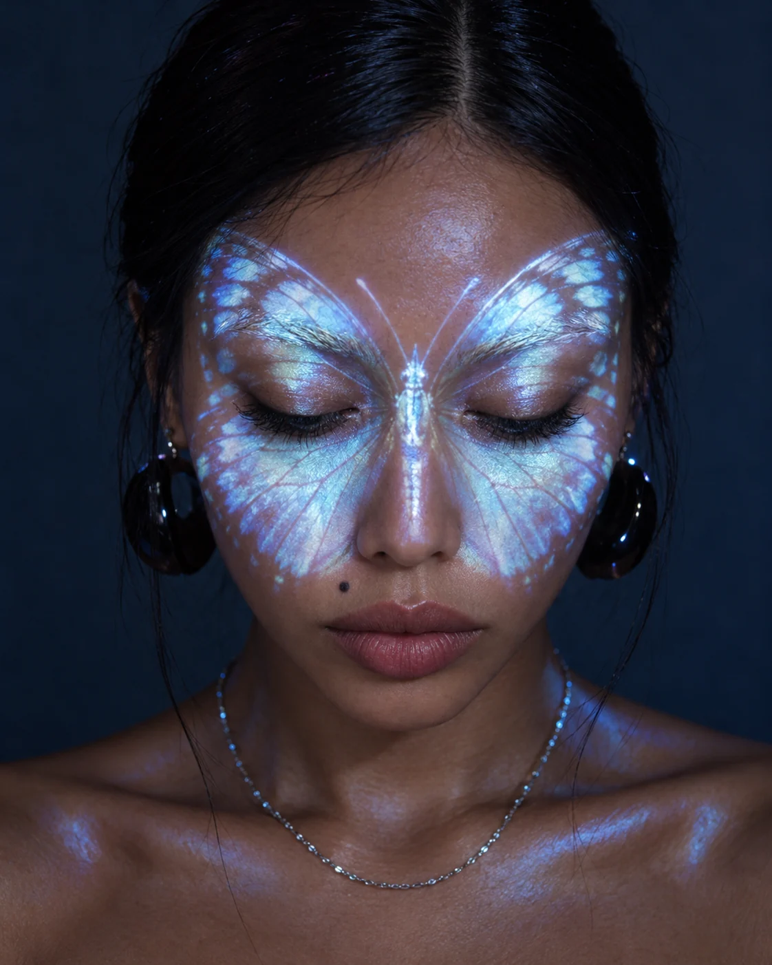 Conceptual portrait with luminous blue butterfly-wing projections across the eyes and nose